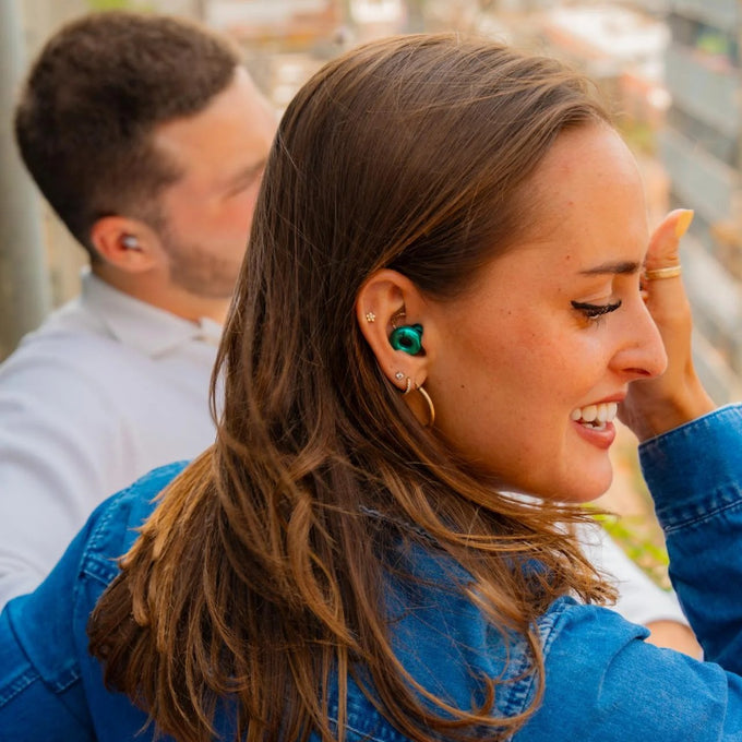 Woman wearing Loop Switch 2 emerald earplugs