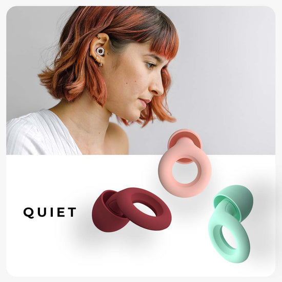 Close up image of a woman wearing Loop Quiet ear plugs. 