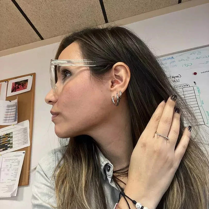 Woman wearing Loop Engage earplugs in an office setting