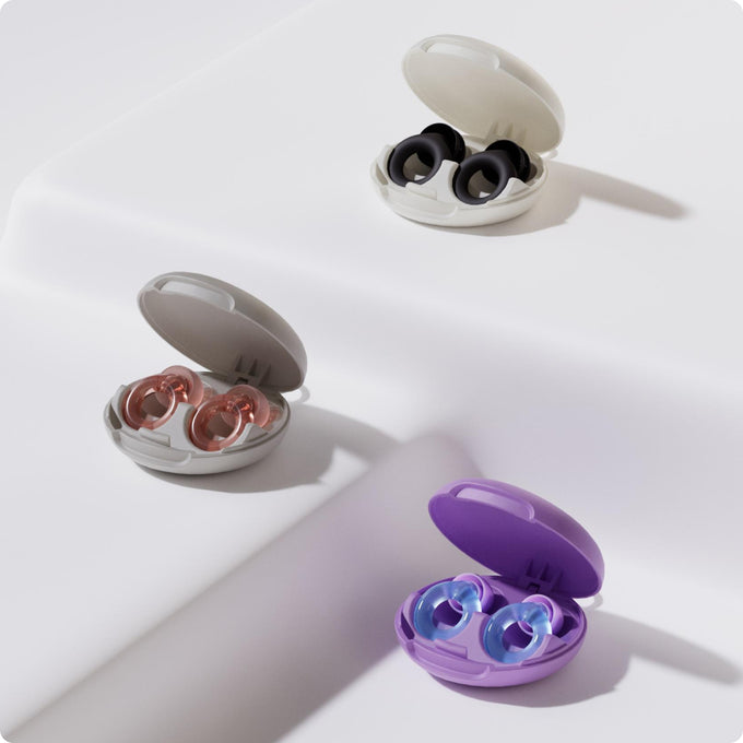 Three pairs of Loop earplugs in open cases on a white background